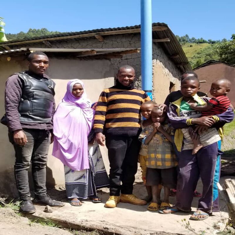 A finished toilet chamber with one of the project beneficiaries.